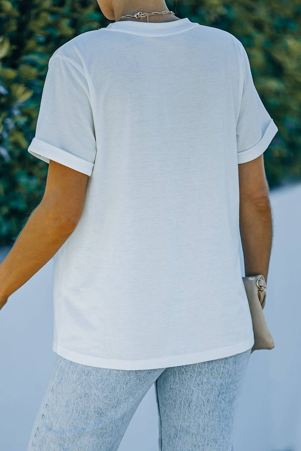 a woman wearing a white shirt and jeans