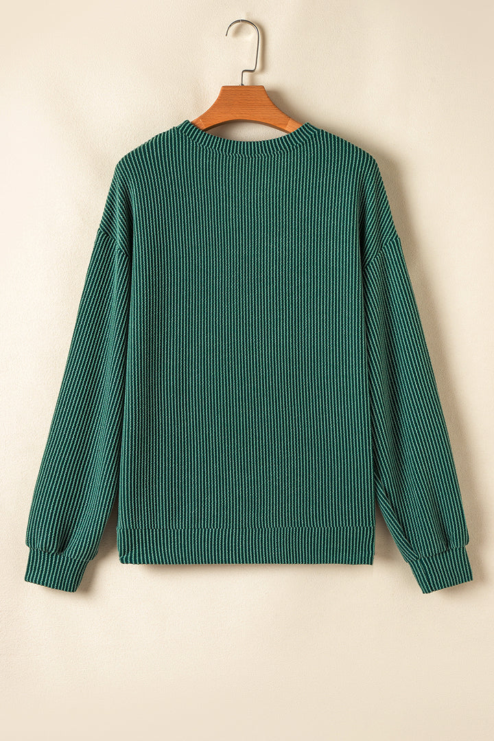 Back view of green Evergreen JOLLY Corded Top showing ribbed texture. Casual holiday apparel from Faith & Co. Boutique.