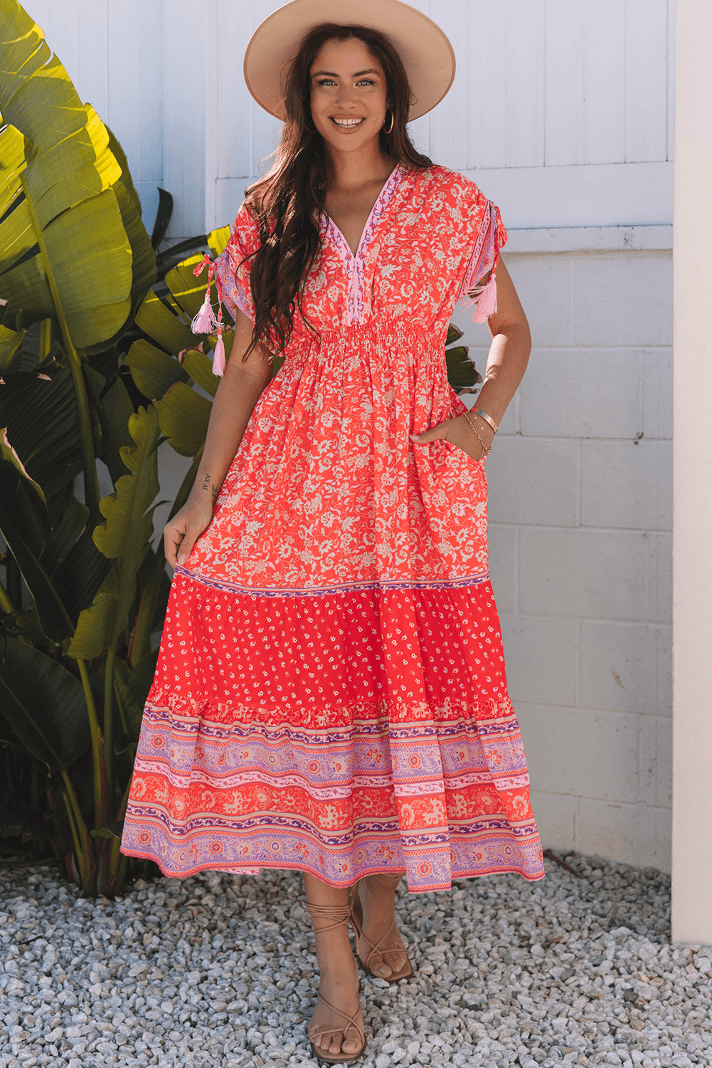 model showing pocket feature in Red Floral Print Tasseled Tied Sleeve Empire Waist Maxi Dress, combining fashion with function