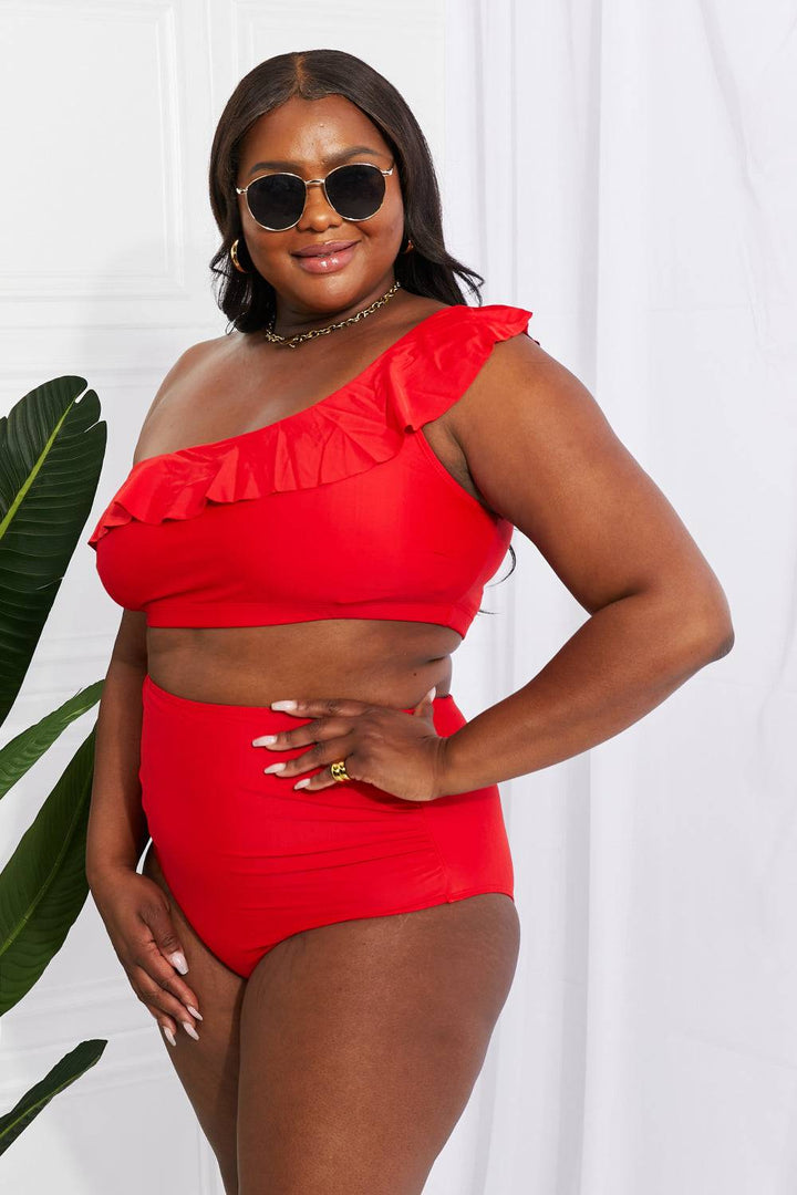 a woman in a red one piece swimsuit