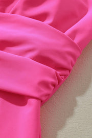 a close up of a pink fabric on a white wall