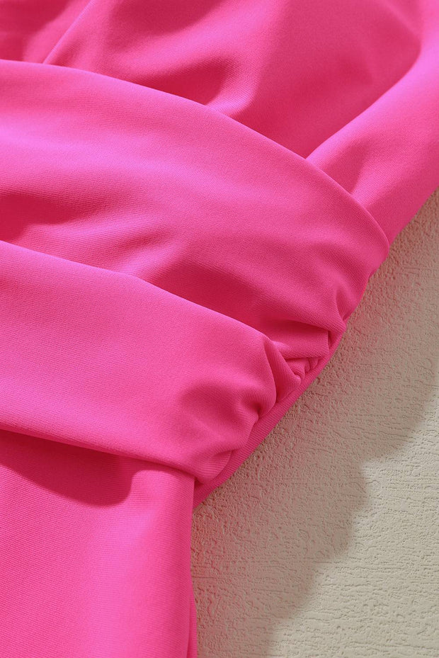a close up of a pink fabric on a white wall