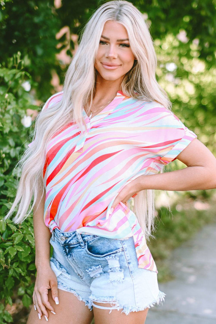 a woman posing for a picture in a striped shirt