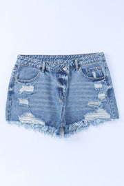 a pair of destroyed denim shorts on a white background