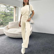 a woman standing in a room with a white couch