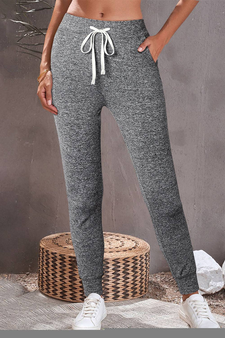 a woman in grey and black sweat pants