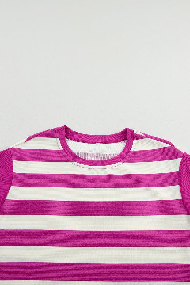 a pink and white striped t - shirt on a white background