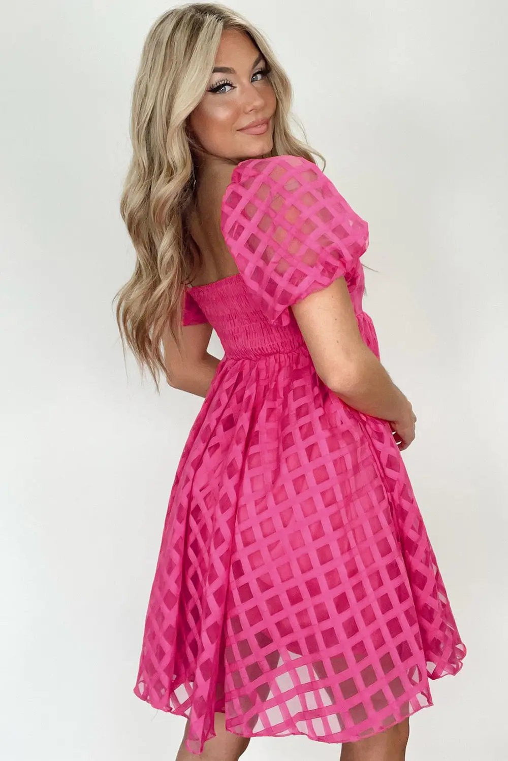 a woman in a pink dress posing for a picture