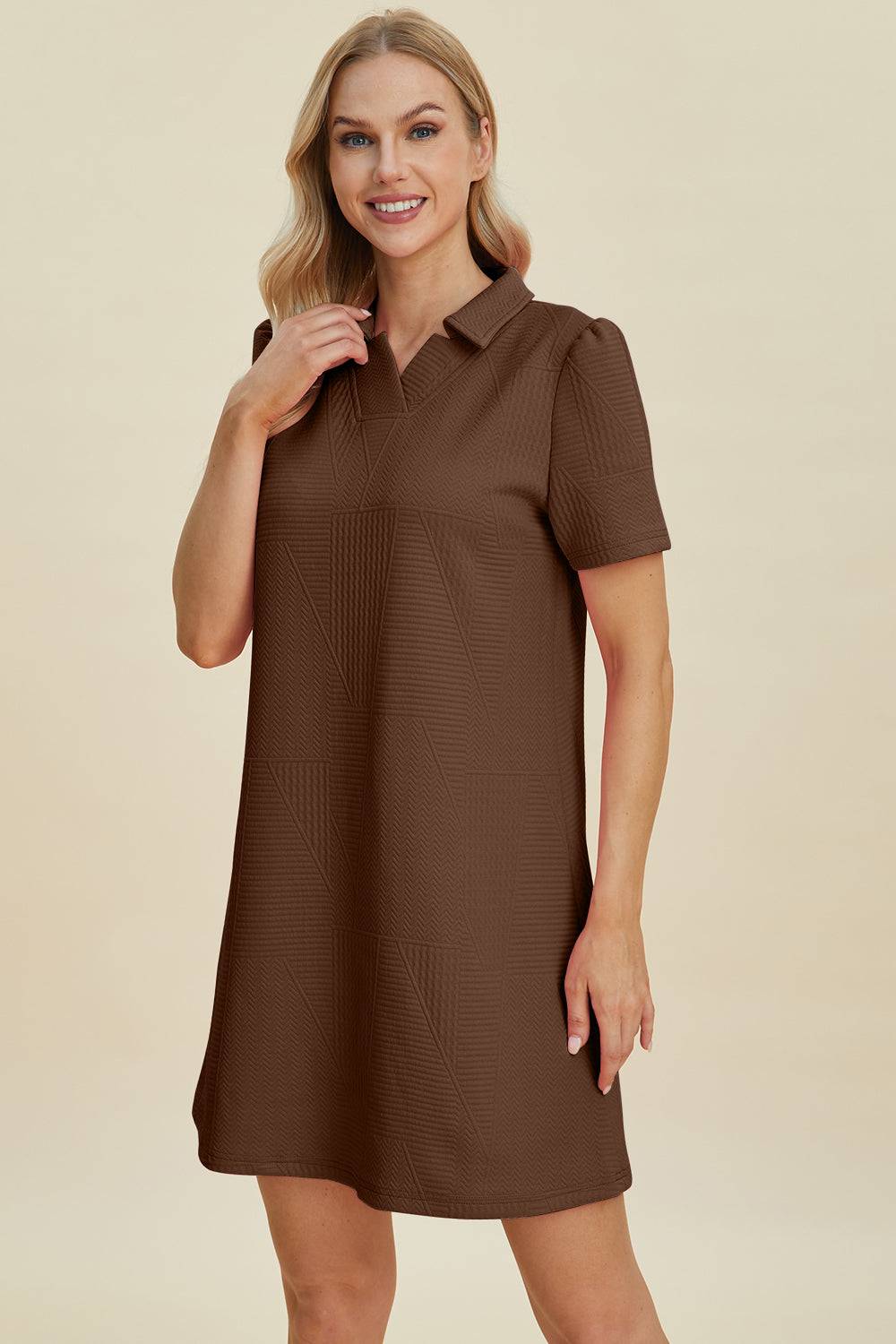 a woman wearing a brown shirt dress