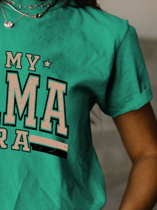 a woman wearing a green shirt that says, my amra