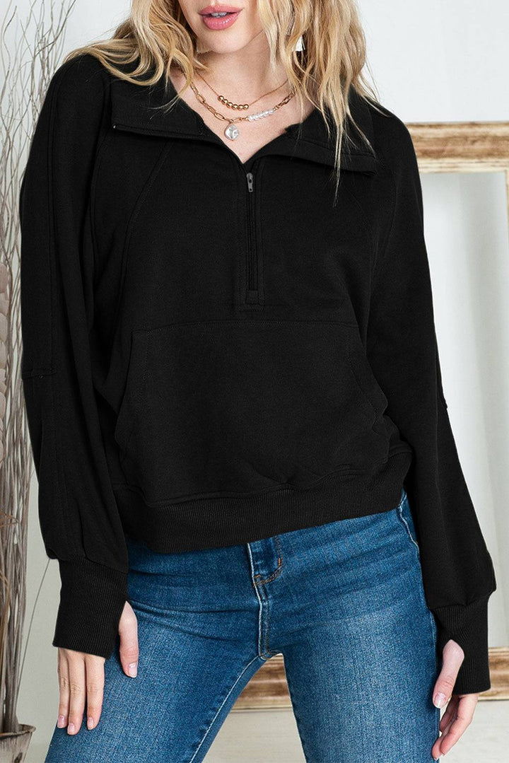 a woman wearing a black sweatshirt and jeans