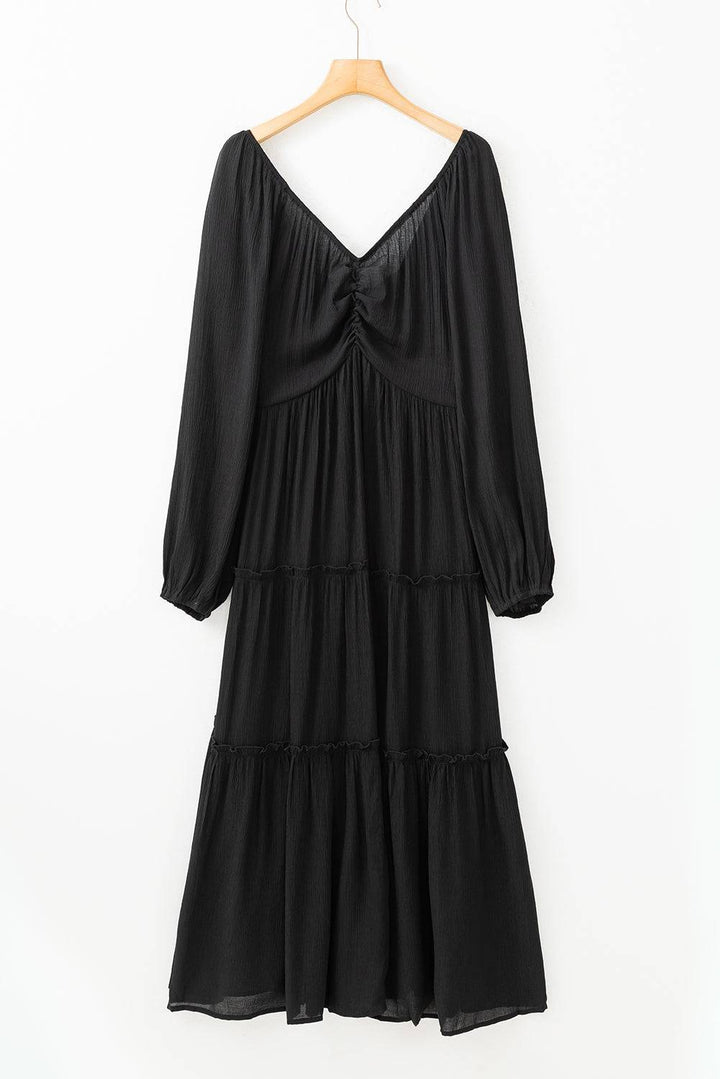 a black dress hanging on a hanger