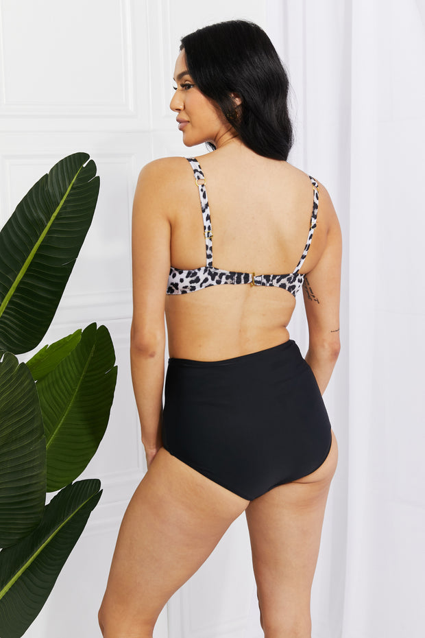 a woman in a leopard print bikini top