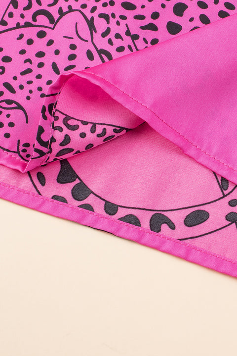 a close up of a pink and black animal print blanket