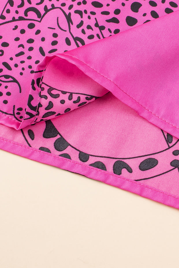 a close up of a pink and black animal print blanket