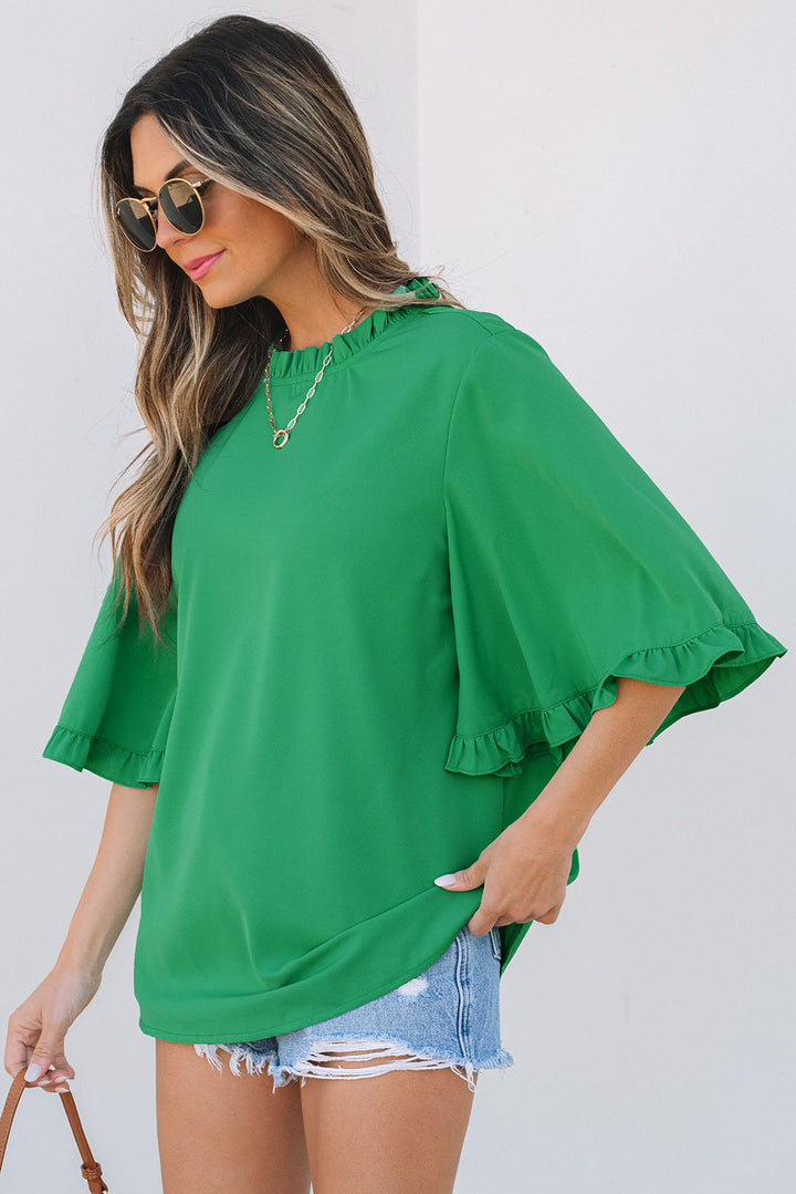 Side view of Green Frilly Round Neck Wide Half Sleeve Blouse paired with shorts, ideal for warm-weather casual wear.