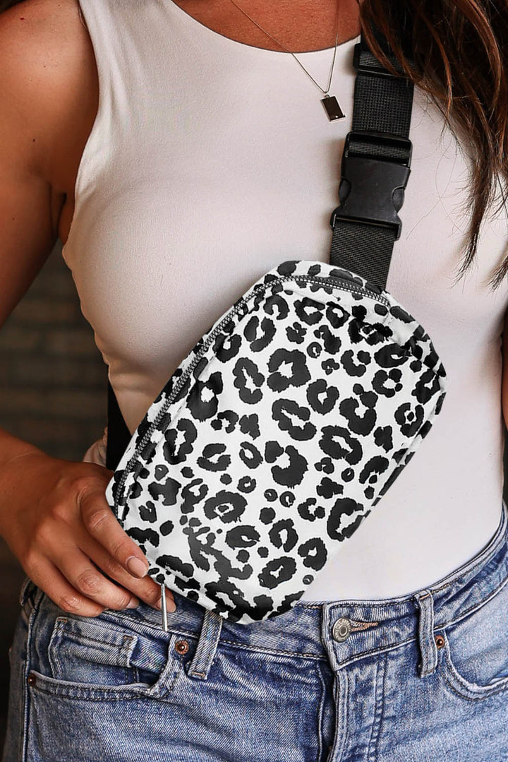 a woman wearing a white tank top holding a black and white leopard print purse