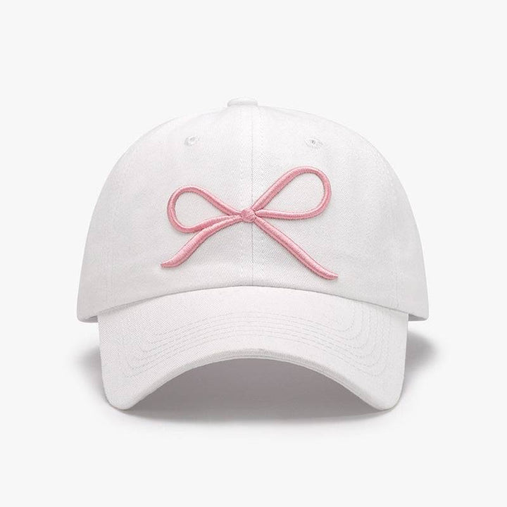 a white hat with a pink bow on it