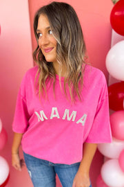 a woman standing in front of balloons wearing a pink shirt