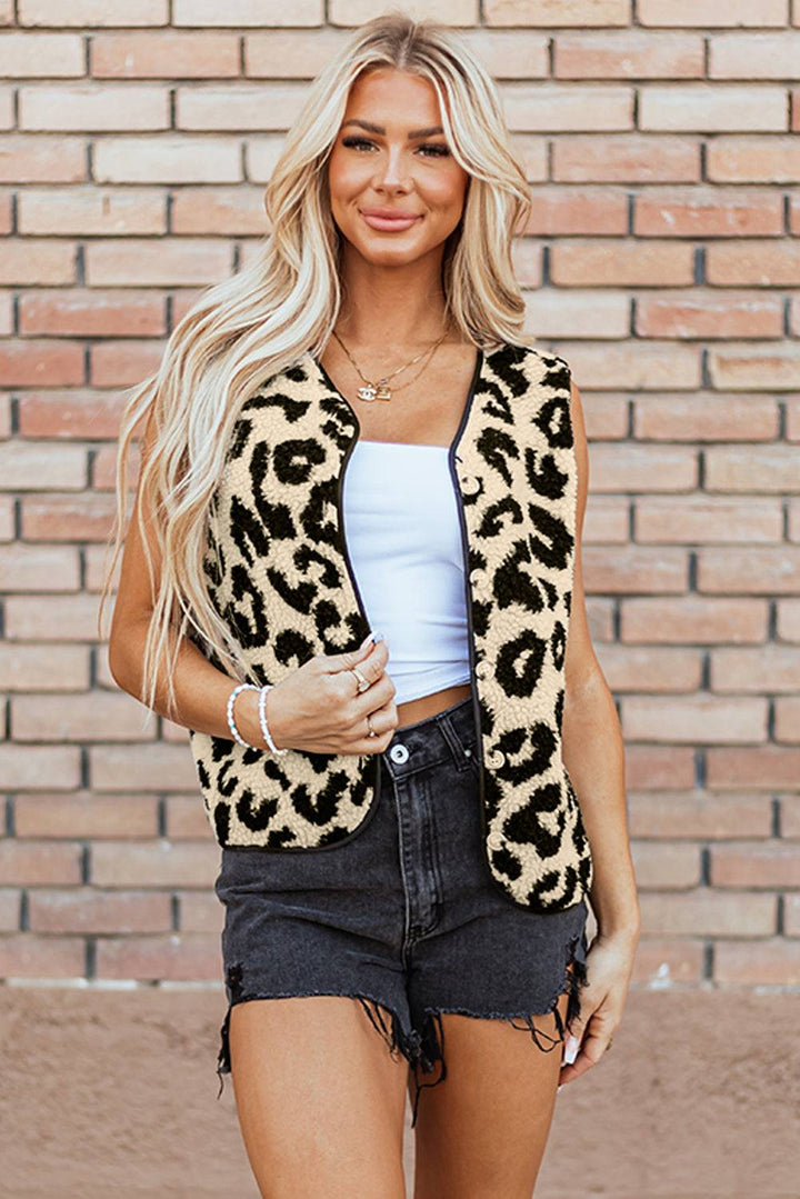 a woman wearing a leopard print vest