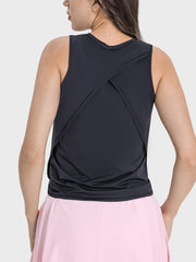 a woman wearing a black top with a pink skirt