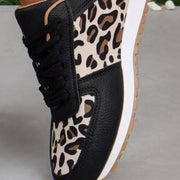 a woman's black and white leopard print sneakers
