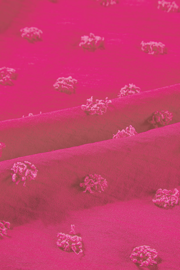 a close up of a pink fabric with small white flowers on it