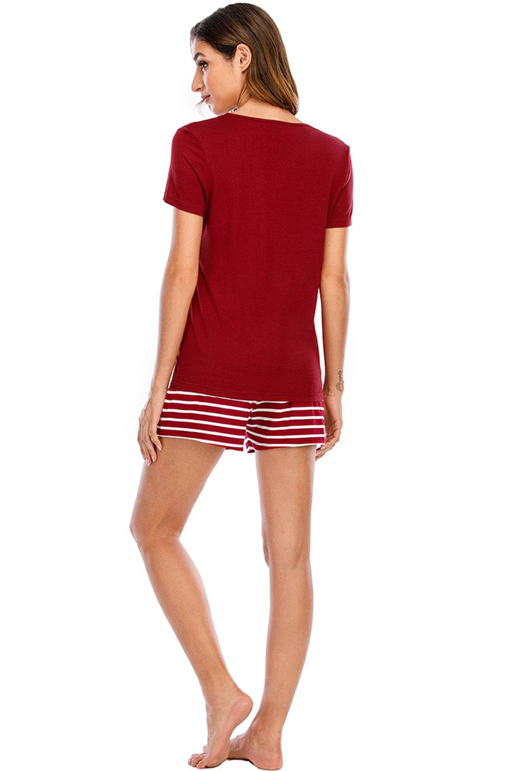 a woman in a red shirt and striped shorts