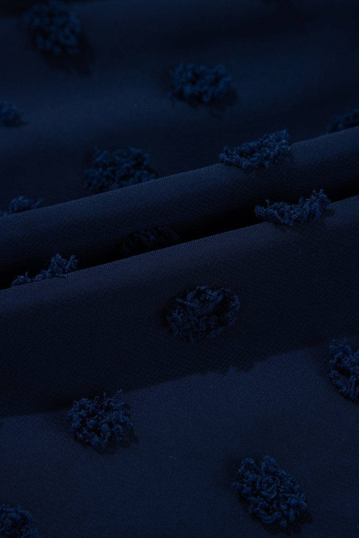 Fabric close-up of Navy Blue Dotty Textured Notched Neck Plus Ruffled Dress showing raised Swiss dot detailing for a chic summer look.