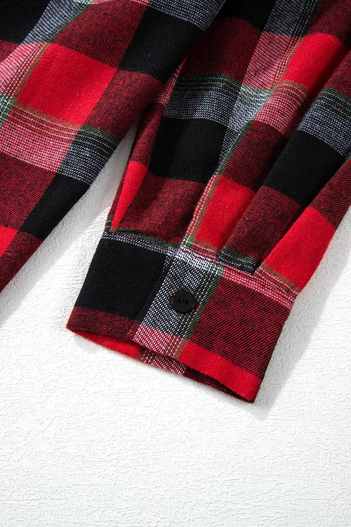 a red and black checkered shirt laying on a white surface