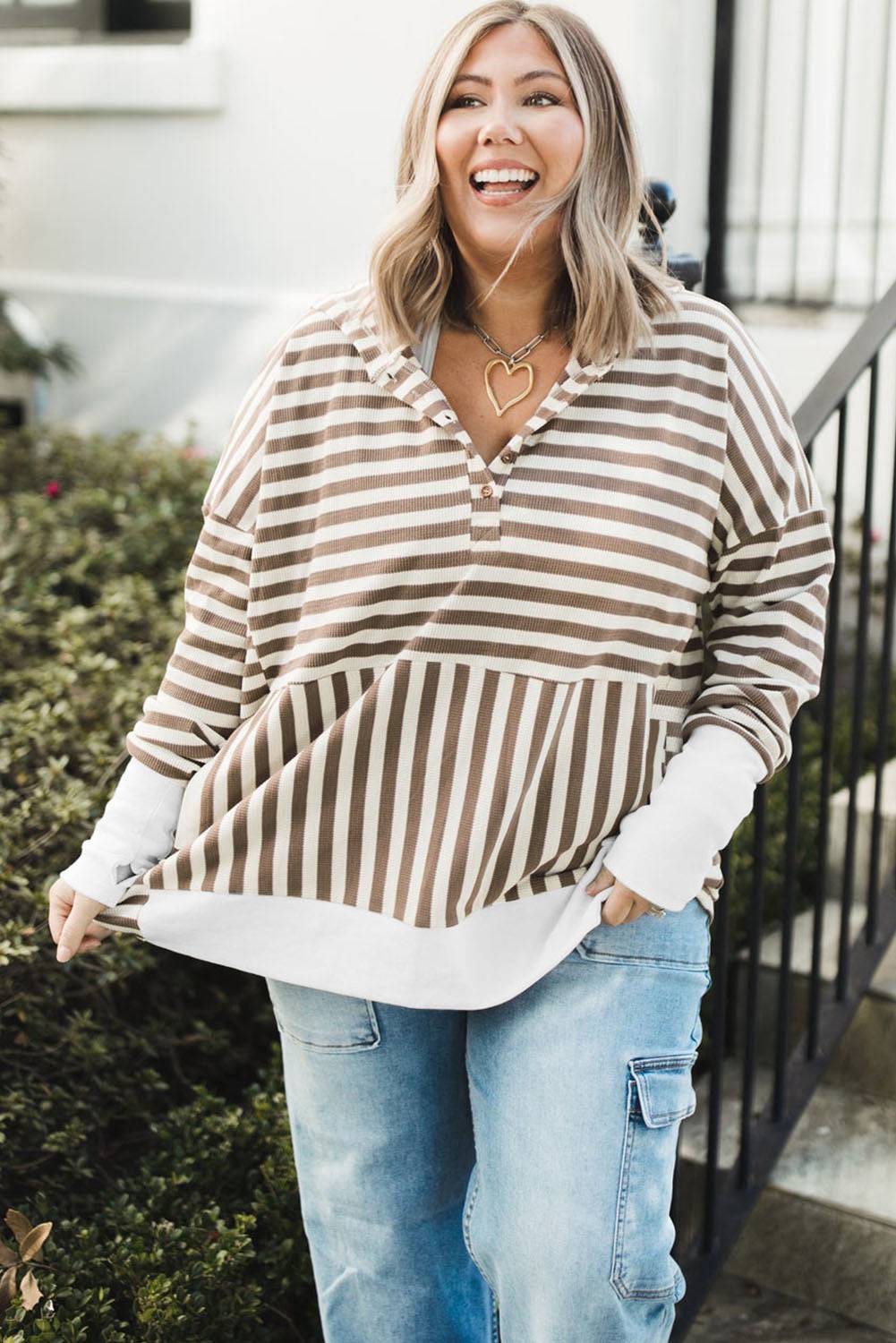 a woman wearing a striped shirt and jeans