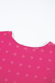 a close up of a pink shirt with small flowers on it