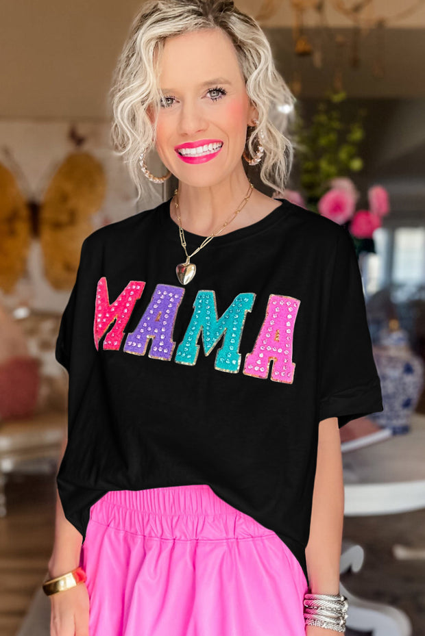 a woman with blonde hair wearing a black shirt and pink skirt