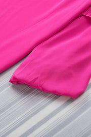 a close up of a pink sheet on a bed