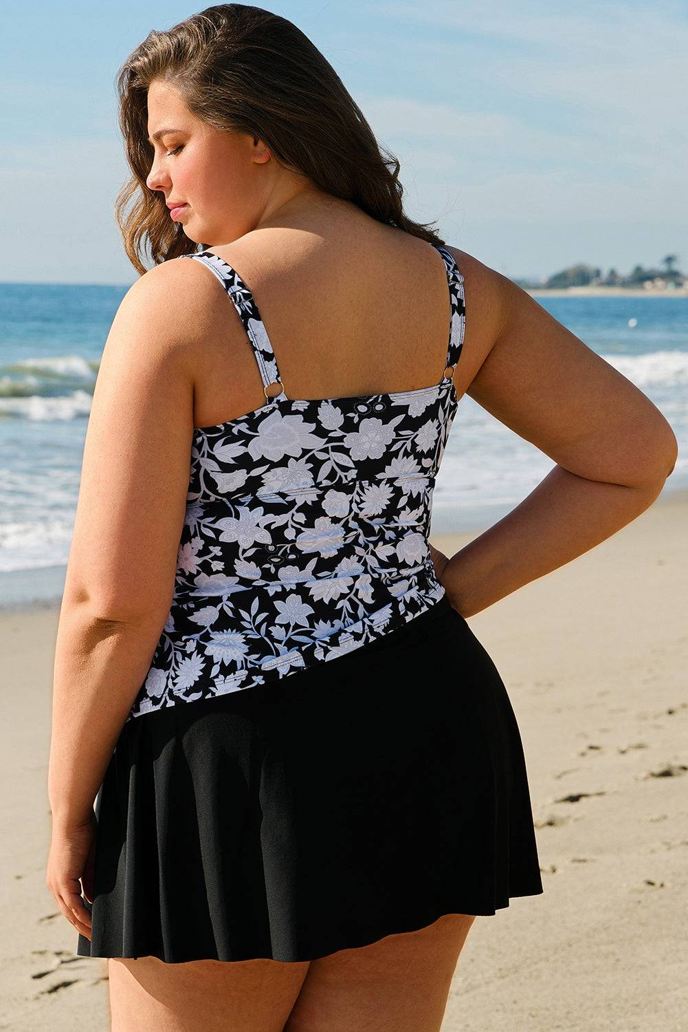 Back view of Black Plus Size Printed Square Neck Drawstring Ruffled Tankini Set showing floral print and flared skirt. Available at Faith & Co. Boutique.