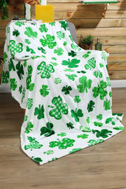 a white blanket with green shamrocks on it