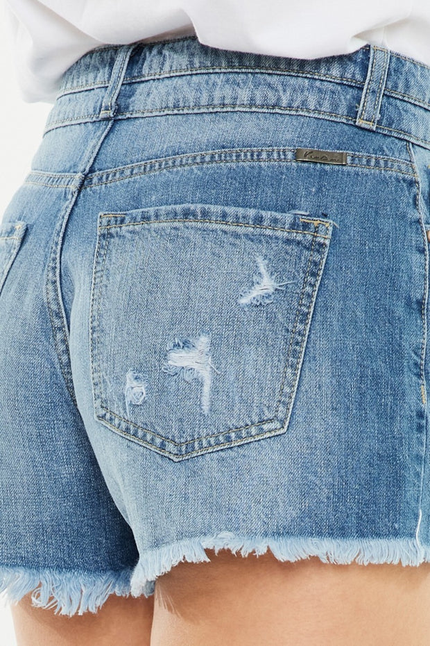 a woman's butt showing the back of her jean shorts