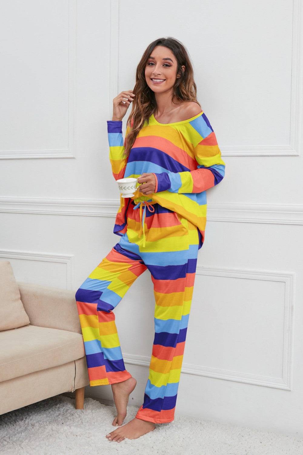 a woman in a rainbow striped outfit posing for a picture
