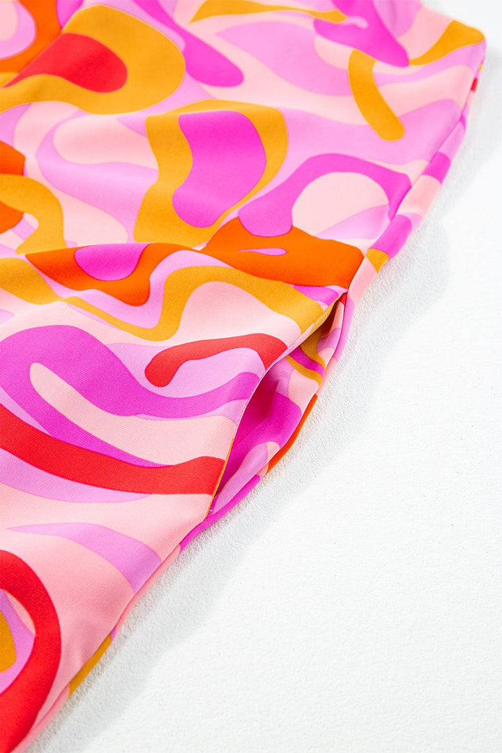 a close up of a pink, orange, and yellow patterned material