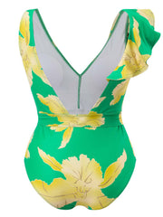 a woman wearing a green and yellow floral print swimsuit