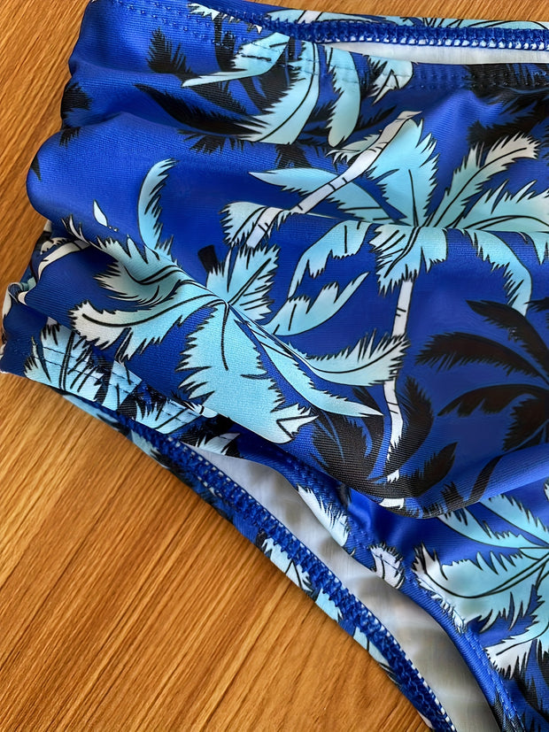 a close up of a blue and white swimsuit on a wooden surface