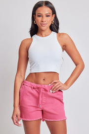 a woman wearing pink shorts and a white crop top