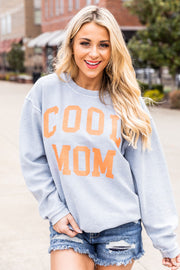 a woman wearing a grey sweater that says cool mom