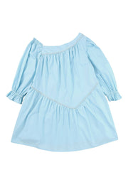 a little girl's blue dress on a white background