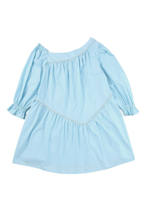a little girl's blue dress on a white background