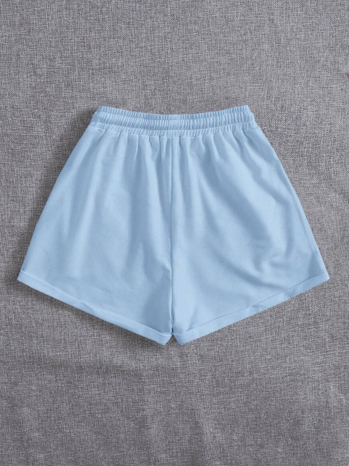 a pair of blue shorts on a grey background
