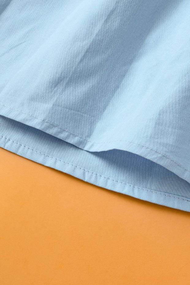 a close up of a blue shirt on an orange surface