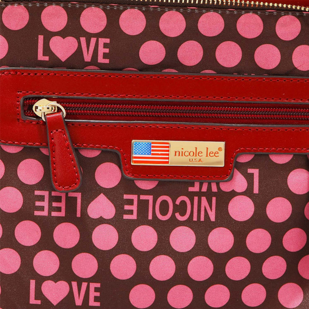 a polka dot purse with a red handle