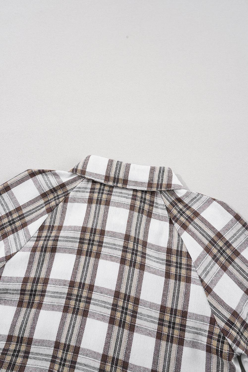 a close up of a shirt with a checkered pattern