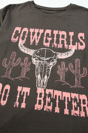 a black t - shirt with a pink print of a bull's skull and